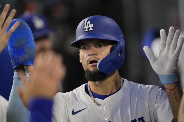 Los Angeles Dodgers center fielder Andy Pages (44) celebrates in the dugout after scoring during the third inning against the San Diego Padres at Dodger Stadium.