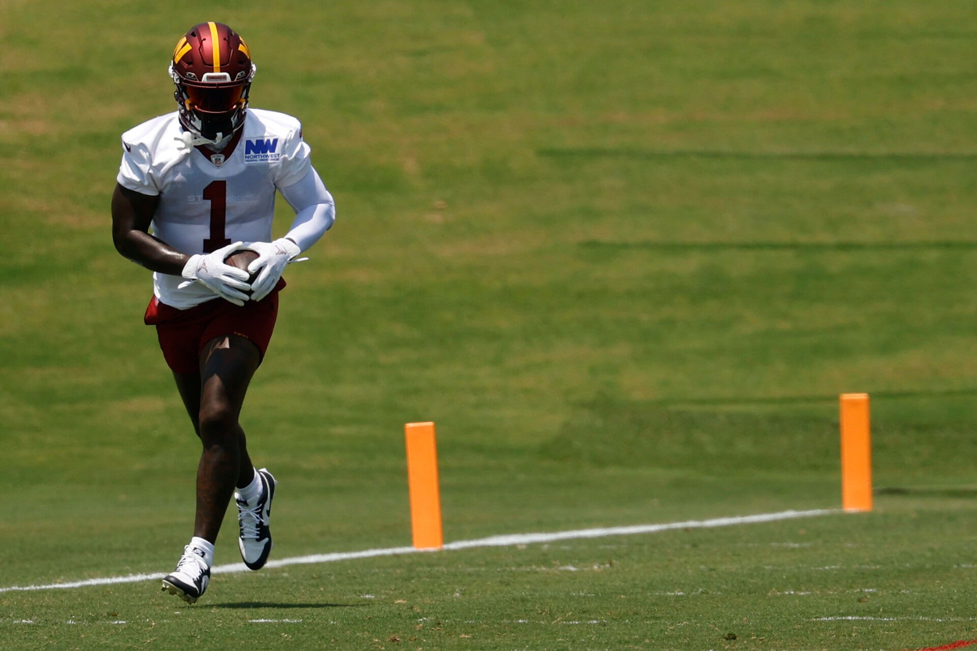 Washington Commanders wide receiver Deebo Samuel Sr. (1) runs with the ball after making a catch during drills on day one of minicamp at Commanders Park.