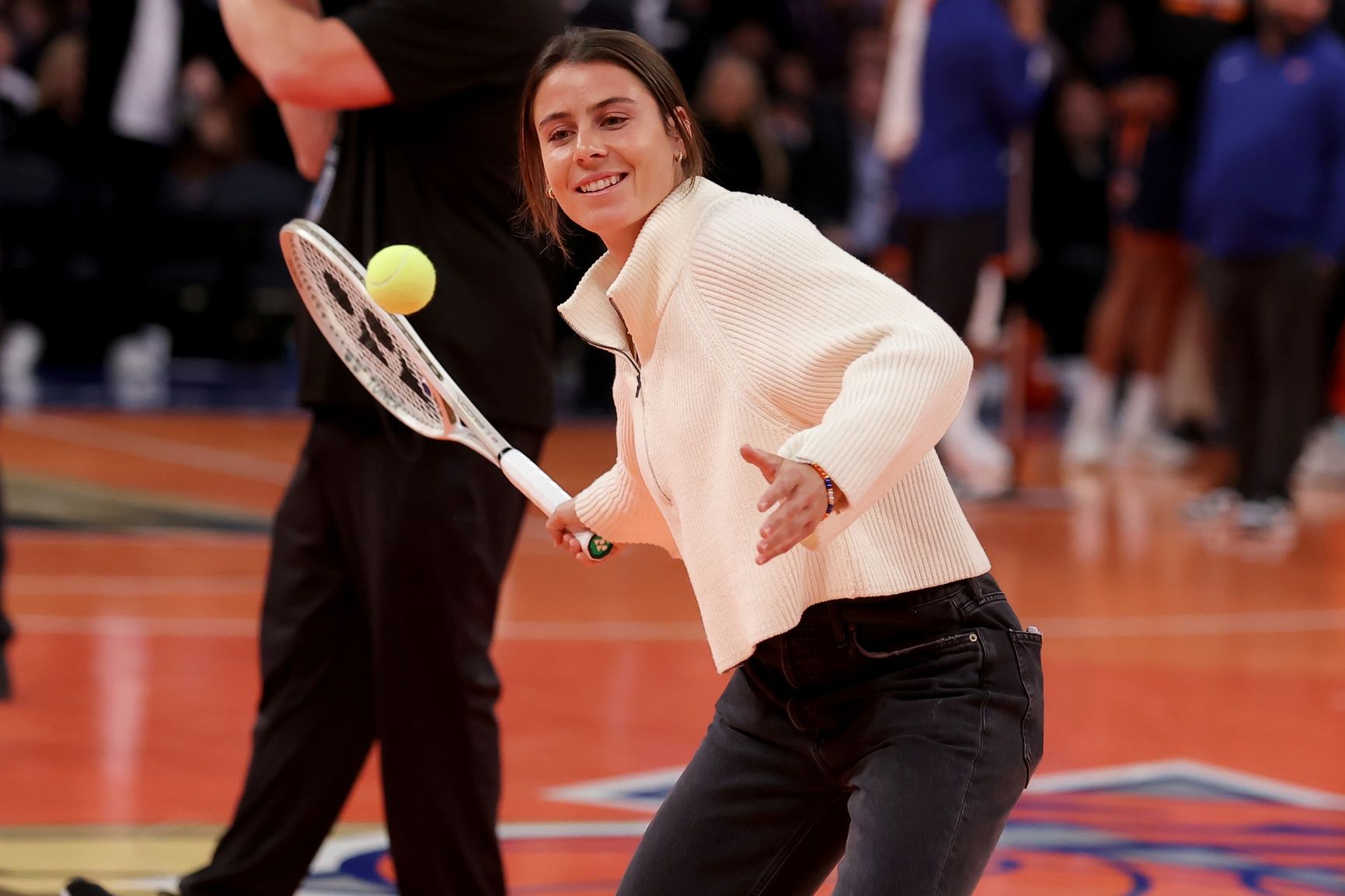 New York, New York, USA; American tennis player Emma Navarro hits tennis balls into the stands during a time out during the third quarter between the New York Knicks and the Orlando Magic at Madison Square Garden.