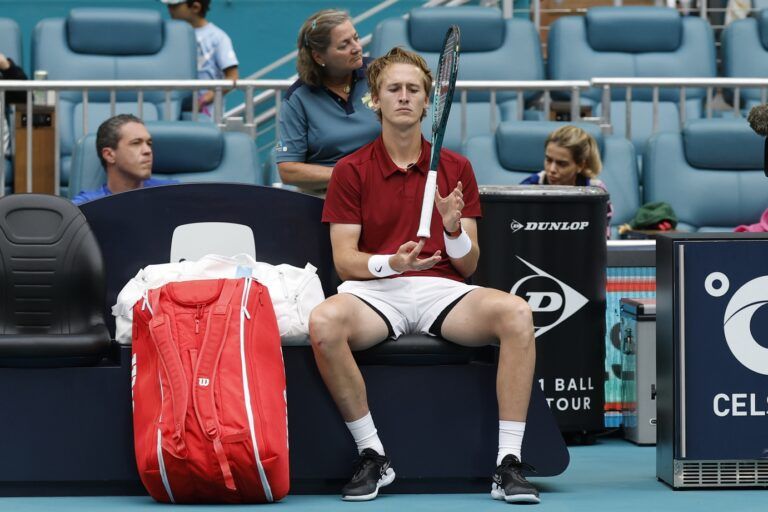 Sebastian Korda (USA) spins his racquet on his finger during court drying efforts in a rain delay in his match against Gael Monfils (FRA)(not pictured) on day eight of the Miami Open at Hard Rock Stadium.