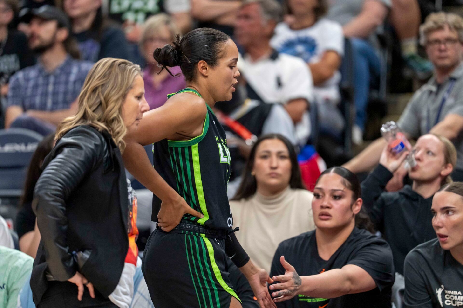 Minnesota Lynx forward Napheesa Collier (24) holds her lower back after exiting the game against the Las Vegas Aces in the second half at Target Center.
