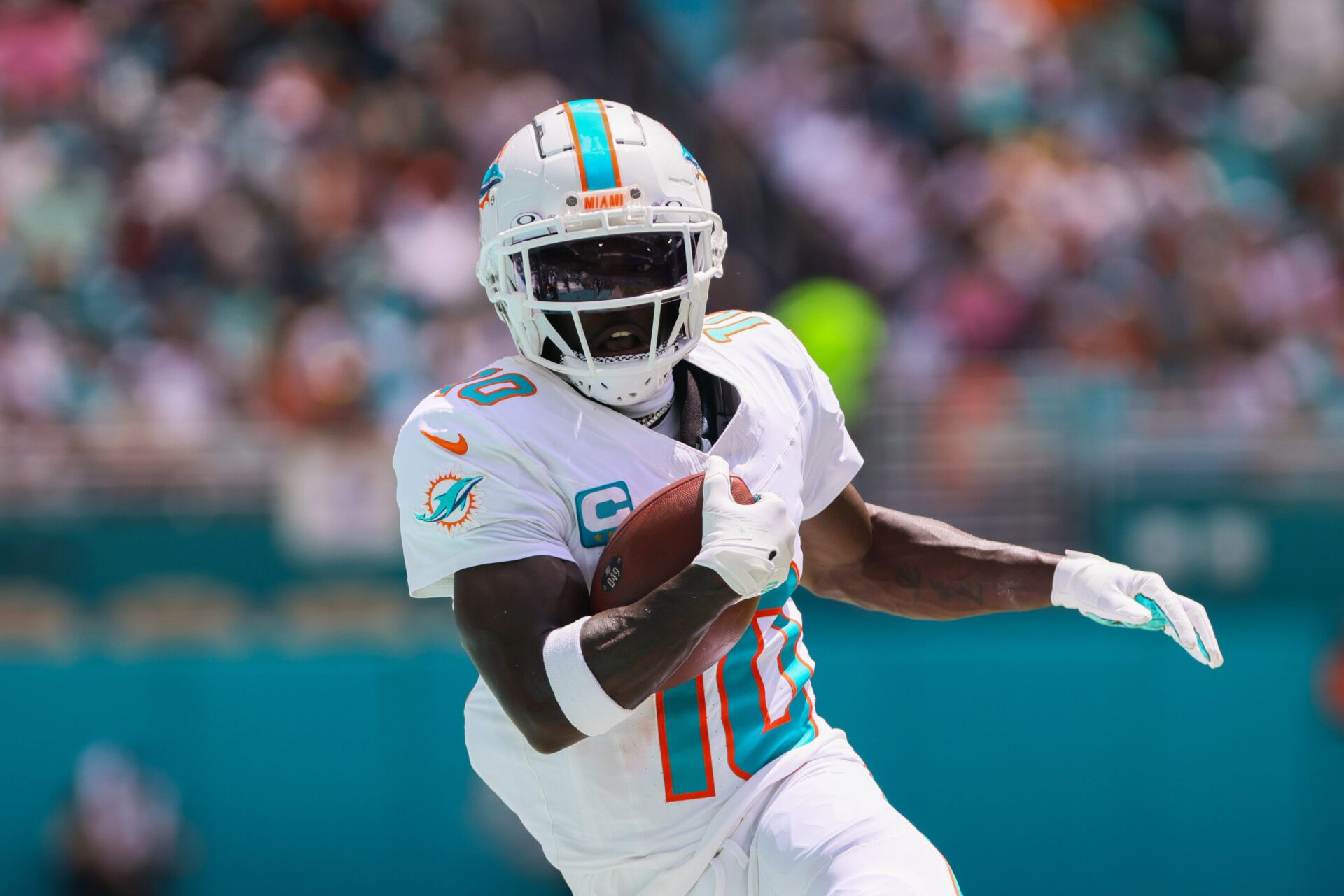 Miami Dolphins wide receiver Tyreek Hill (10) runs with the football against the Jacksonville Jaguars during the first quarter at Hard Rock Stadium.