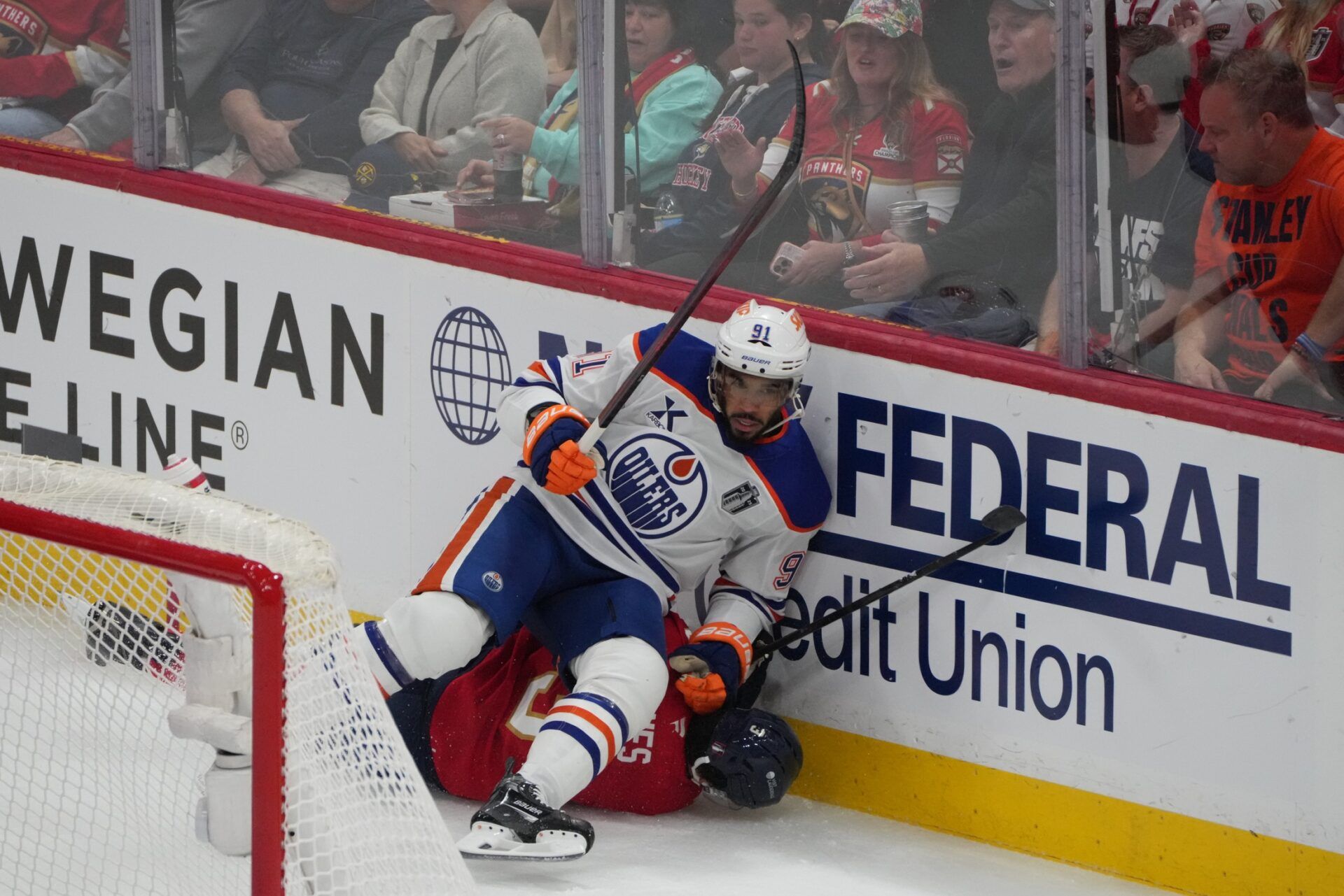 Edmonton Oilers left wing Evander Kane (91) boards Florida Panthers defenseman Seth Jones (3) during the first period in game four of the 2025 Stanley Cup Final at Amerant Bank Arena.