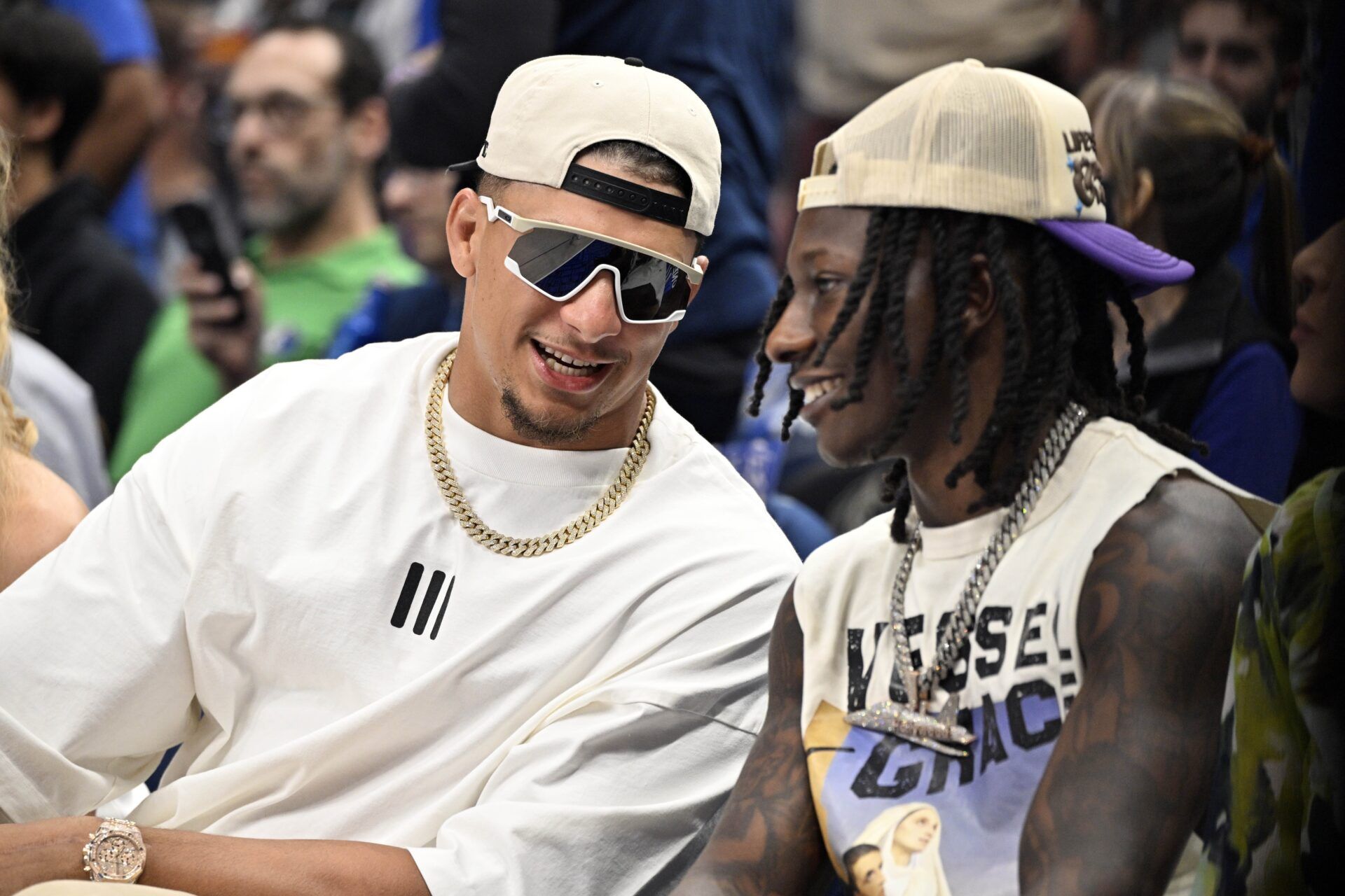 Kansas City Chiefs players Patrick Mahomes (left) and Hollywood Brown (right) look on in the first half between the Dallas Mavericks and the Minnesota Timberwolves during game three of the western conference finals for the 2024 NBA playoffs at American Airlines Center.