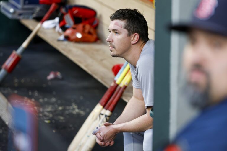 Boston Red Sox starting pitcher Walker Buehler (0) sits in the dugout after being relieved for during the fourth inning against the Seattle Mariners at T-Mobile Park.