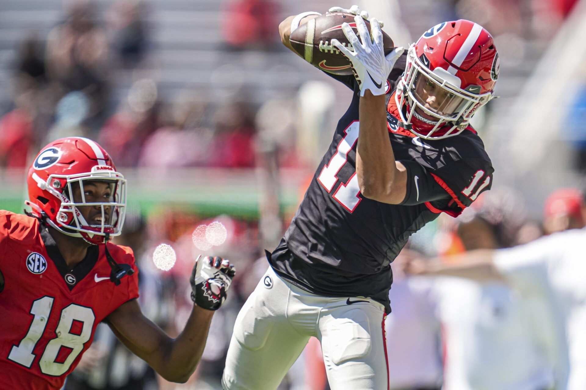 Georgia Bulldogs wide receiver Talyn Taylor (11) tries to make a catch behind defensive back Jontae Gilbert (18) during the Georgia Spring game at Sanford Stadium.