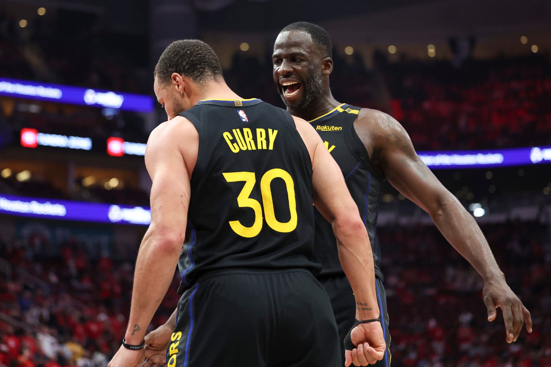 Golden State Warriors forward Draymond Green (23) celebrates with guard Stephen Curry (30) during game seven of the first round for the 2025 NBA Playoffs against the Houston Rockets at Toyota Center.