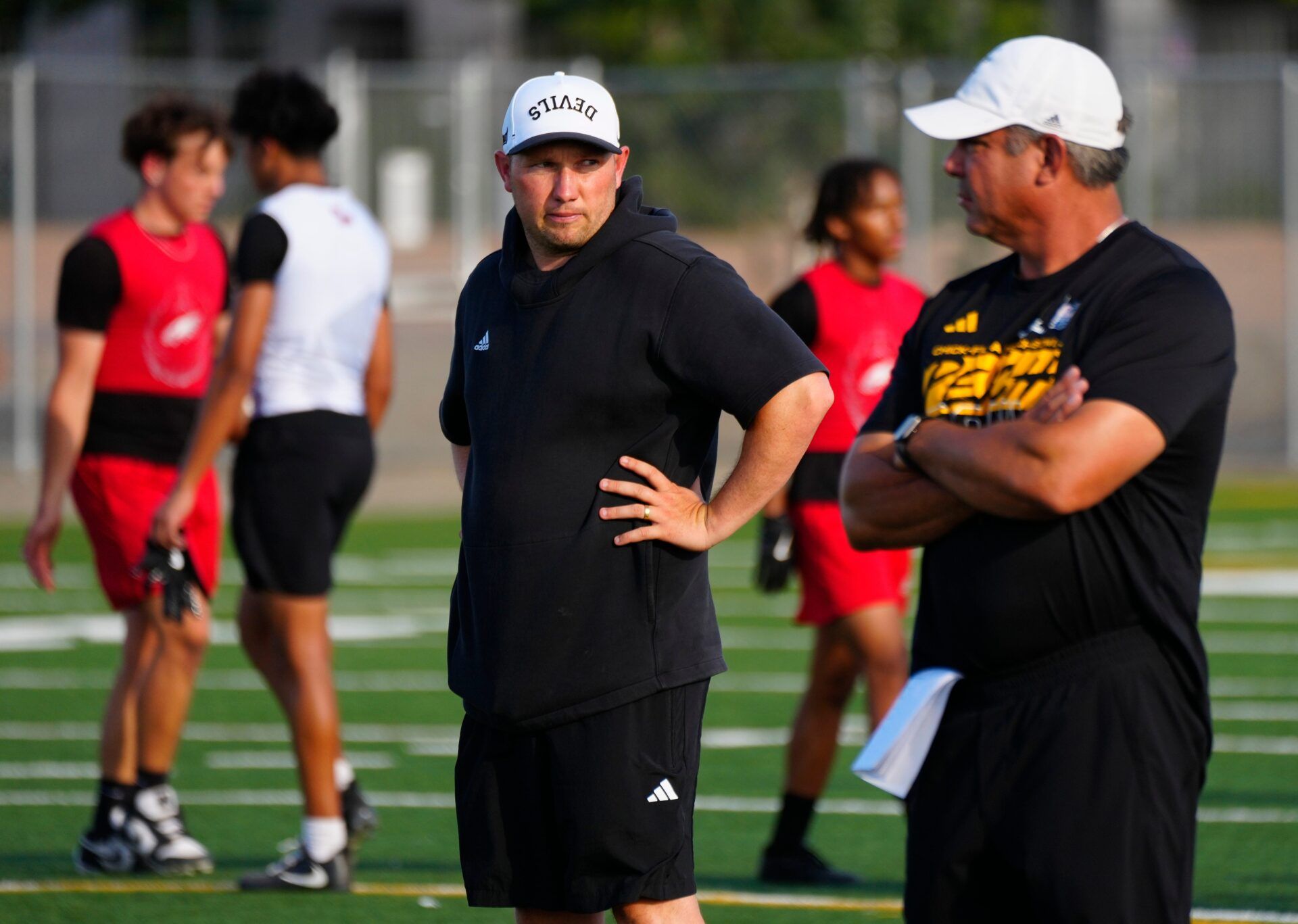 ASU head coach Kenny Dillingham and running back coach Shaun Aguano watch the Chandler game during an ASU 7 on 7 tournament in Tempe, on June 12, 2025. Aguano is a former head coach of Chandler High School.