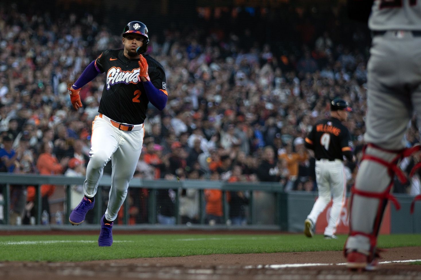 San Francisco Giants shortstop Willy Adames (2) scores on an RBI double by designated hitter Rafael Devers during the third inning against the Cleveland Guardians at Oracle Park.