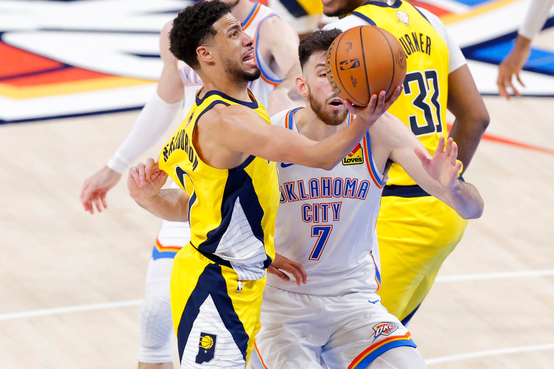Indiana Pacers guard Tyrese Haliburton (0) drives to the basket past Oklahoma City Thunder forward Chet Holmgren (7) during the fourth quarter in game five of the 2025 NBA Finals at Paycom Center.