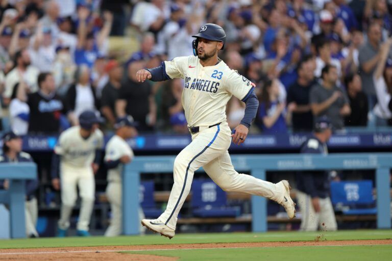Los Angeles Dodgers outfielder Michael Conforto (23) scores a run against the San Francisco Giants in the second inning at Dodger Stadium.
