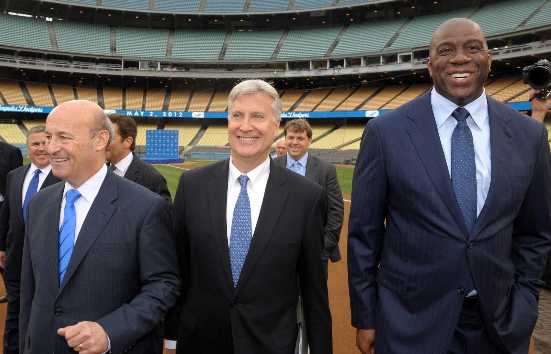 Members of the Guggenheim baseball management team arrive at press conference to announce their purchase of the Los Angeles Dodgers at Dodger Stadium. From left: Stan Kasten and Mark Walter and Magic Johnson.