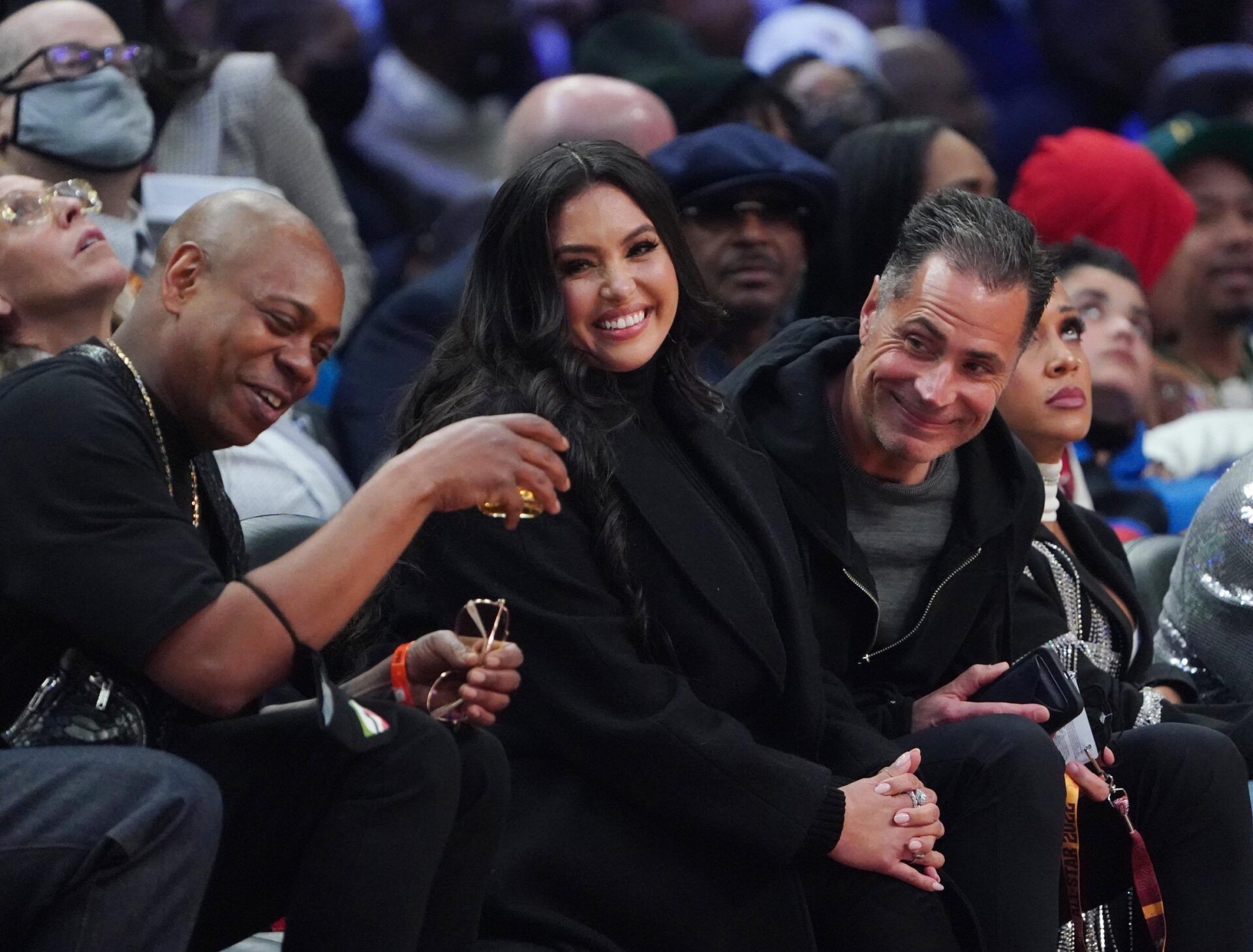 Vanessa Bryant sits between Dave Chapelle (left) and Lakers general manager Rob Pelinka (right) during the 2022 NBA All-Star Game at Rocket Mortgage FieldHouse.