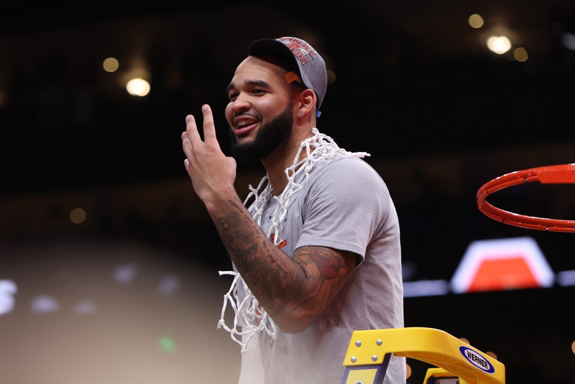 Auburn Tigers forward Johni Broome (4) cuts down the net after winning the South Regional final of the 2025 NCAA tournament against the Michigan State Spartans at State Farm Arena.