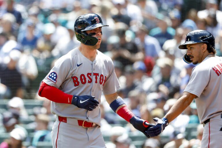 Boston Red Sox third baseman Marcelo Mayer (39) shakes hands with second baseman David Hamilton (17) after hitting a solo-home run against the Seattle Mariners during the second inning at T-Mobile Park.