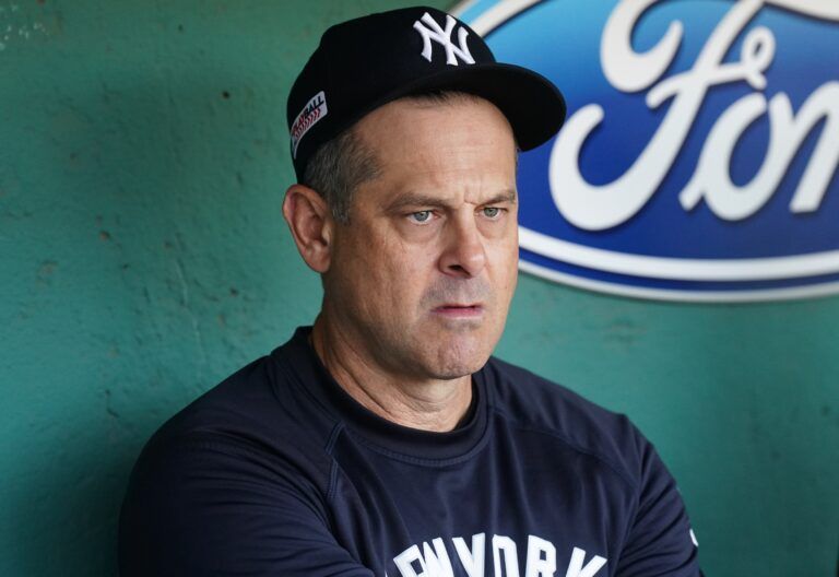 New York Yankees manager Aaron Boone (17) in the dugout before the start of the game against the Boston Red Sox at Fenway Park.
