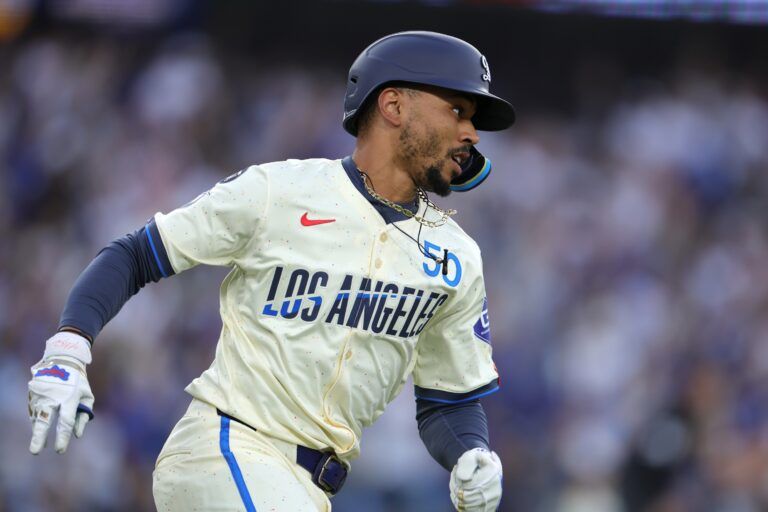 Los Angeles Dodgers shortstop Mookie Betts (50) rounds first base after hitting a double in the second inning against the San Francisco Giants at Dodger Stadium.