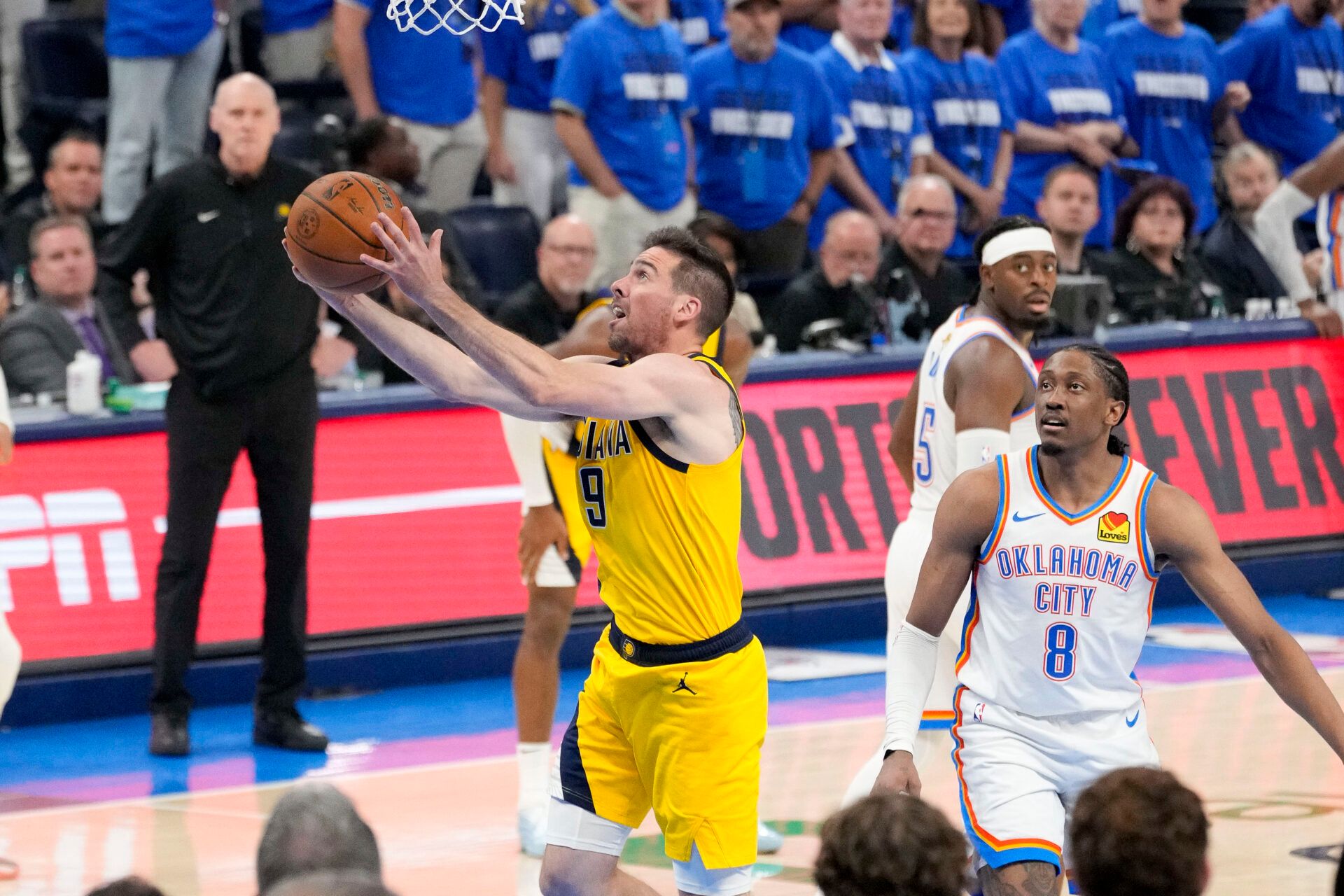 Indiana Pacers guard T.J. McConnell (9) drives to the basket past Oklahoma City Thunder forward Jalen Williams (8) during the third quarter in game five of the 2025 NBA Finals at Paycom Center.