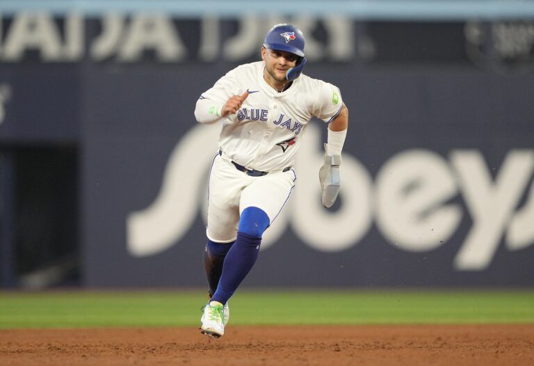 Toronto Blue Jays shortstop Bo Bichette (11) heds to third base on a double hit by right fielder Addison Barger (not pictured) against the Arizona Diamondbacks during the sixth inning at Rogers Centre.
