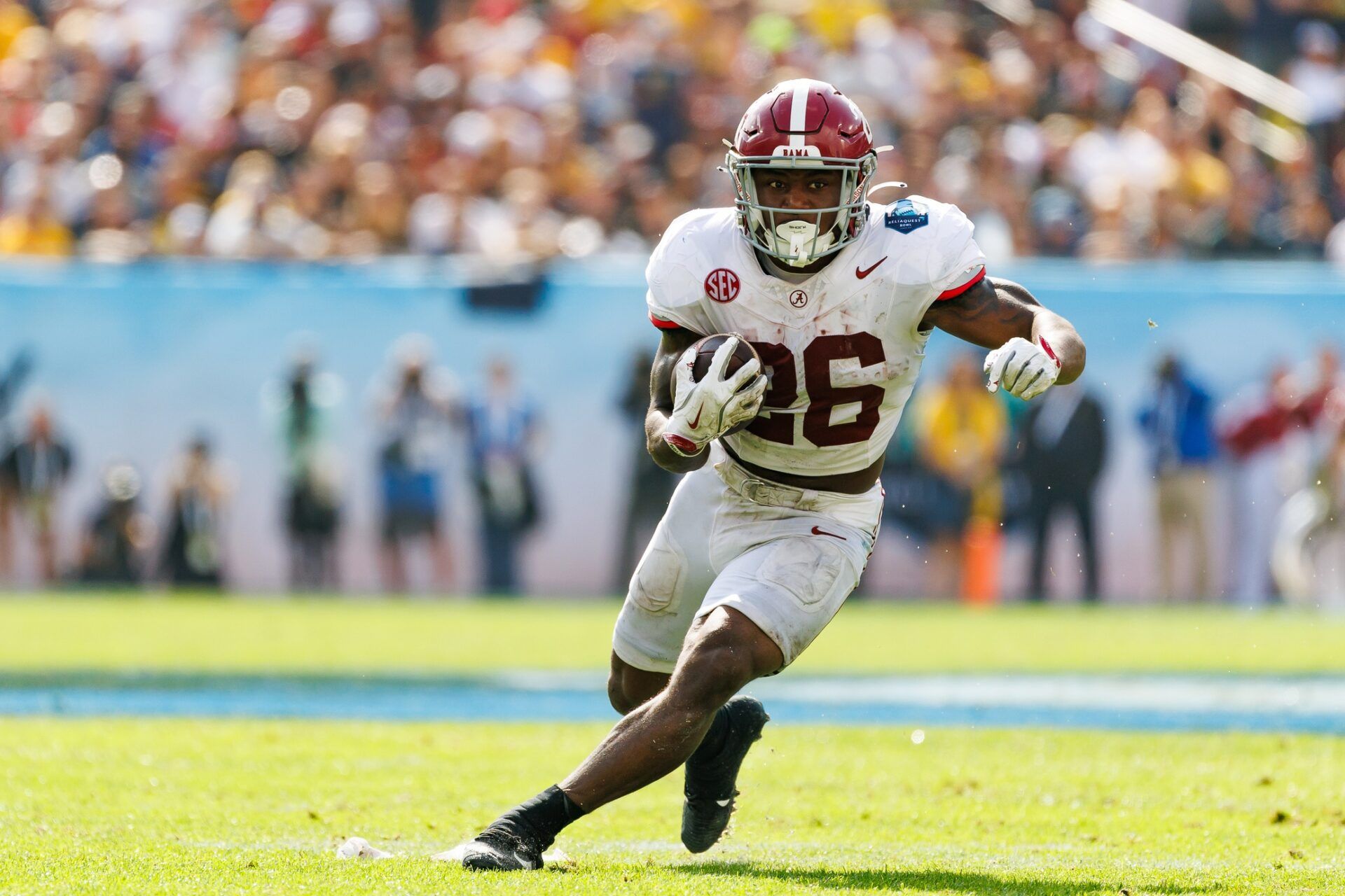 Alabama Crimson Tide running back Jam Miller (26) rushes with the ball against the Michigan Wolverines during the first half at Raymond James Stadium.