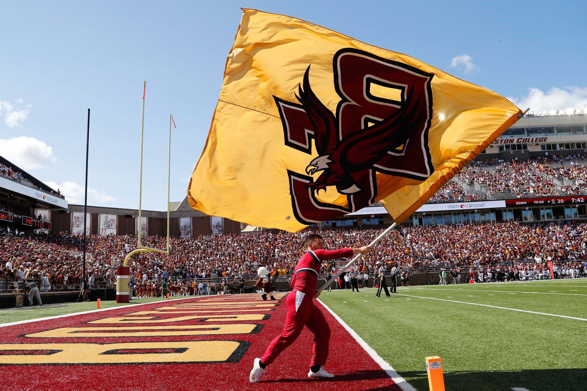 A Boston College Eagles cheerleader waves a flag after a touchdown against the Colgate Raiders during the first half at Alumni Stadium.