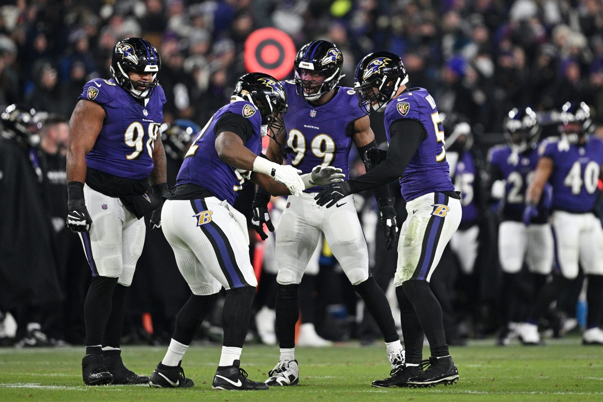 Baltimore Ravens defensive tackle Nnamdi Madubuike (92) celebrates with linebacker Kyle Van Noy (53) and linebacker Odafe Oweh (99) after a tackle against the Pittsburgh Steelers in the third quarter in an AFC wild card game at M&T Bank Stadium.