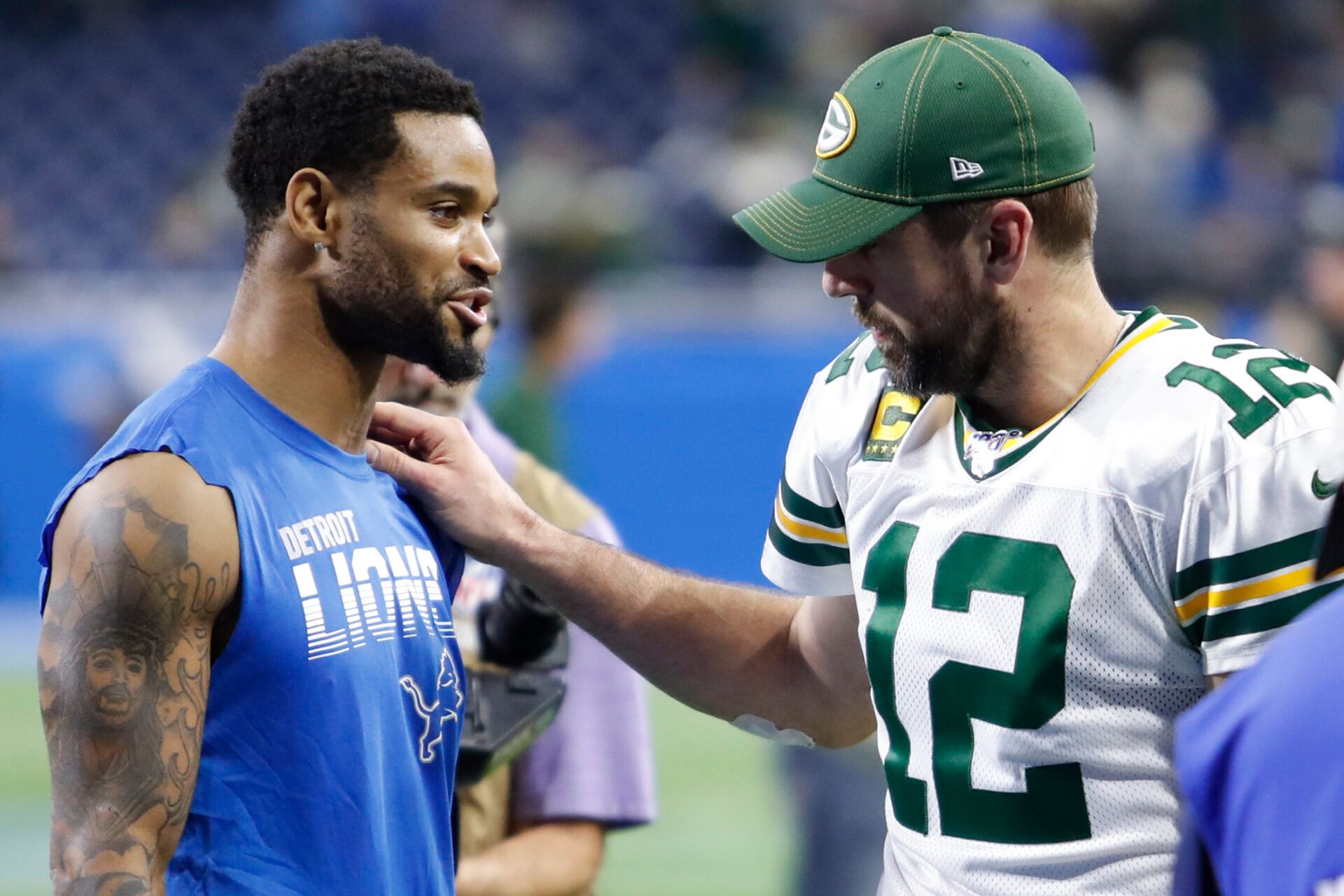 Green Bay Packers quarterback Aaron Rodgers (12) and Detroit Lions cornerback Darius Slay (23) talk after the game at Ford Field.