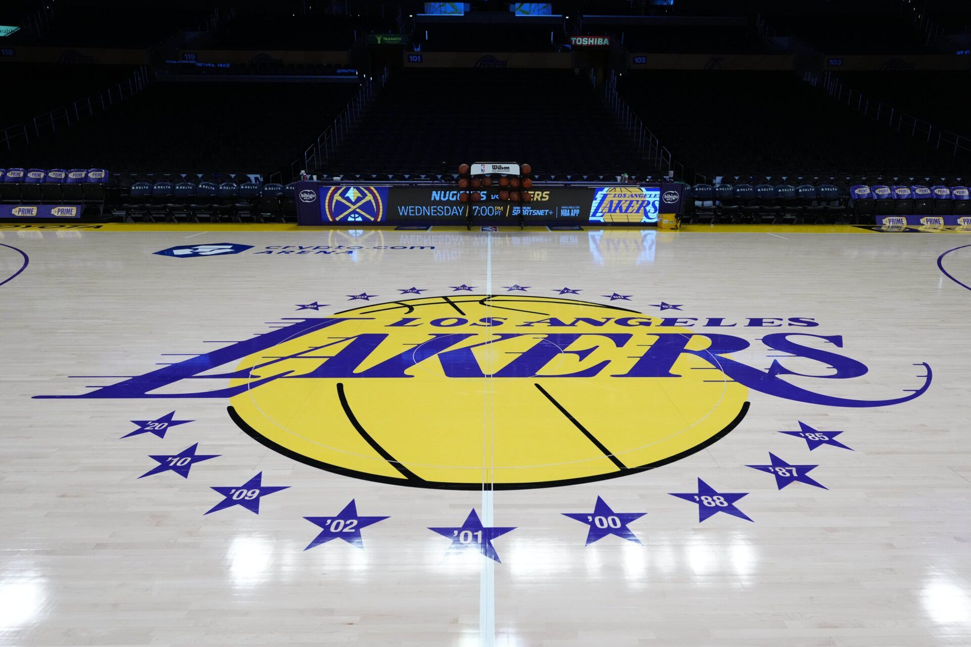 The Los Angeles Lakers logo at midcourt at Crypto.com Arena.