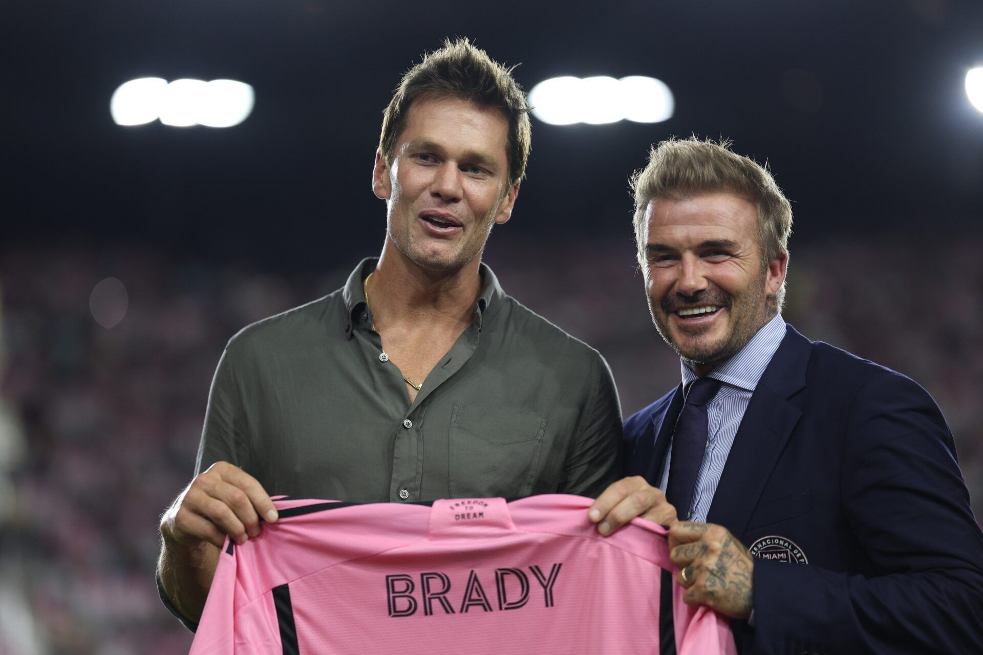 Inter Miami president and co-owner David Beckham presents a jersey to former NFL player Tom Brady  during the match between the FC Cincinnati and the Inter Miami at Chase Stadium.