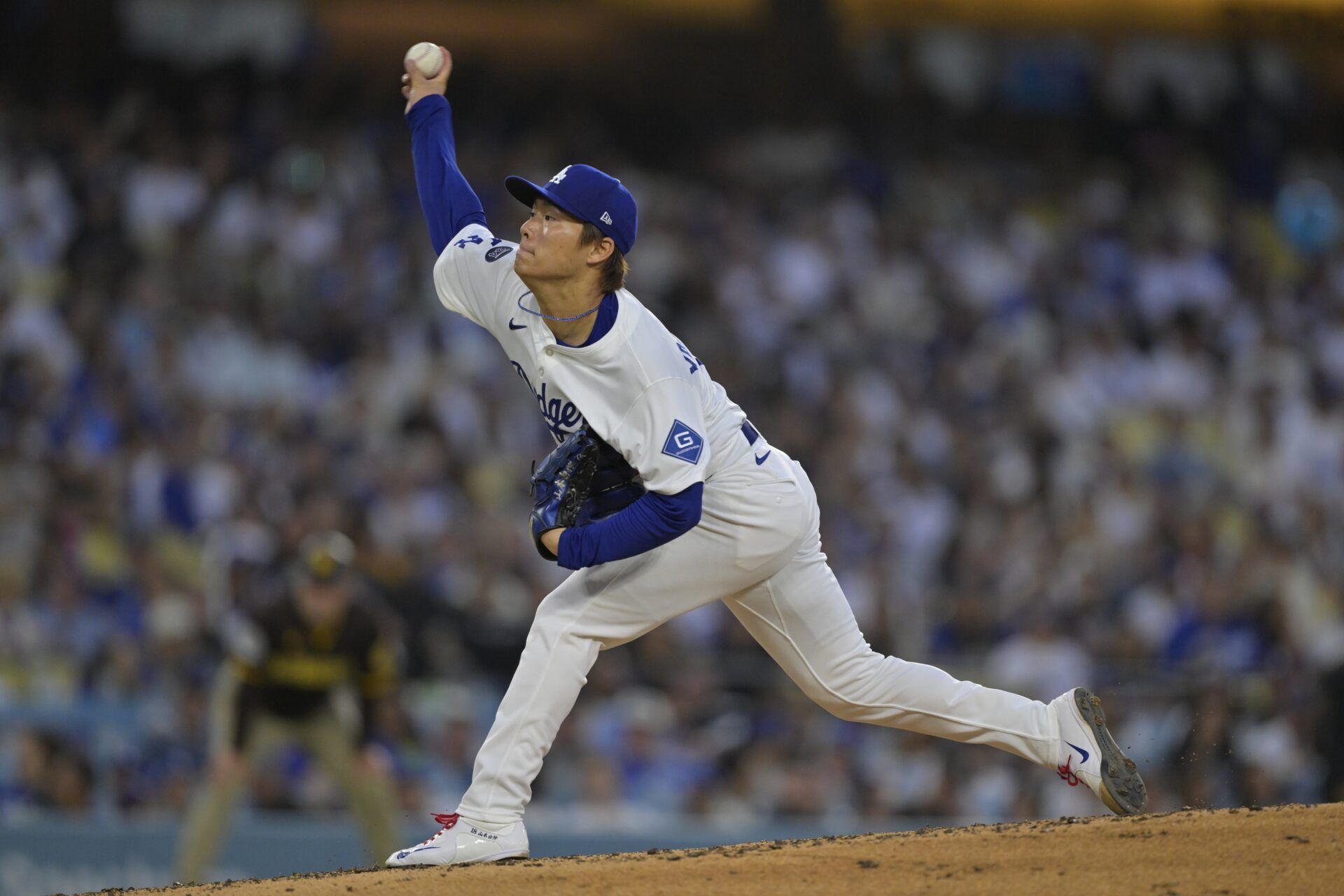Los Angeles Dodgers pitcher Yoshinobu Yamamoto (18) delivers a pitch during the fourth inning against the San Diego Padres at Dodger Stadium.