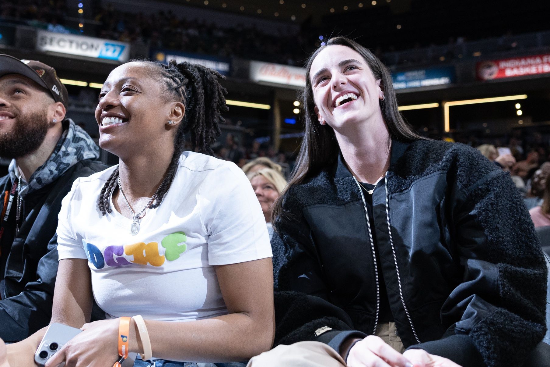 Indiana Fever guard Caitlin Clark (22) and guard Kelsey Mitchell (0) take in the game between the Indiana Pacers and the Memphis Grizzlies at Gainbridge Fieldhouse.
