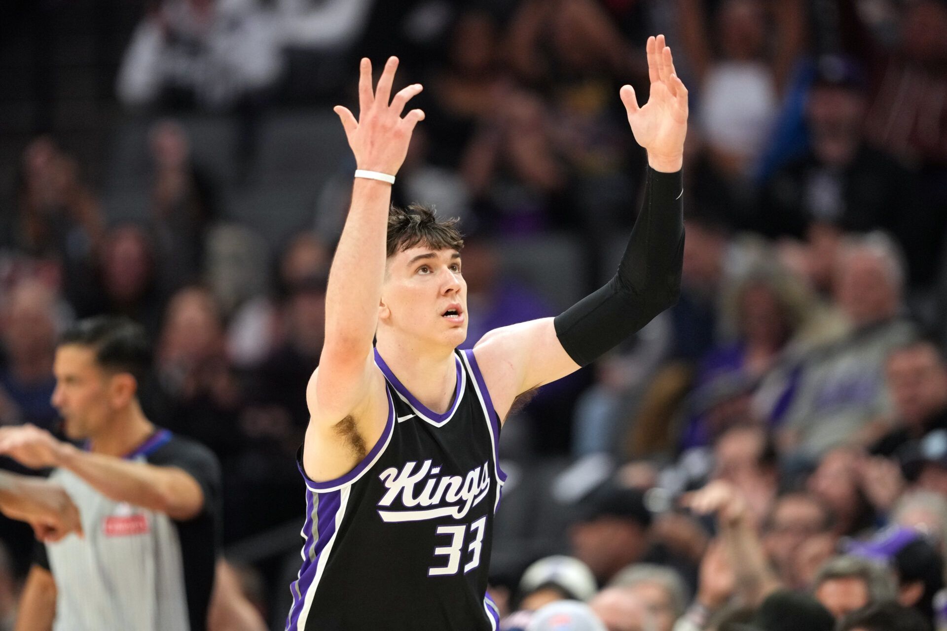 Sacramento Kings forward Jake LaRavia (33) gestures after making a three point basket against the Milwaukee Bucks during the second quarter at Golden 1 Center.
