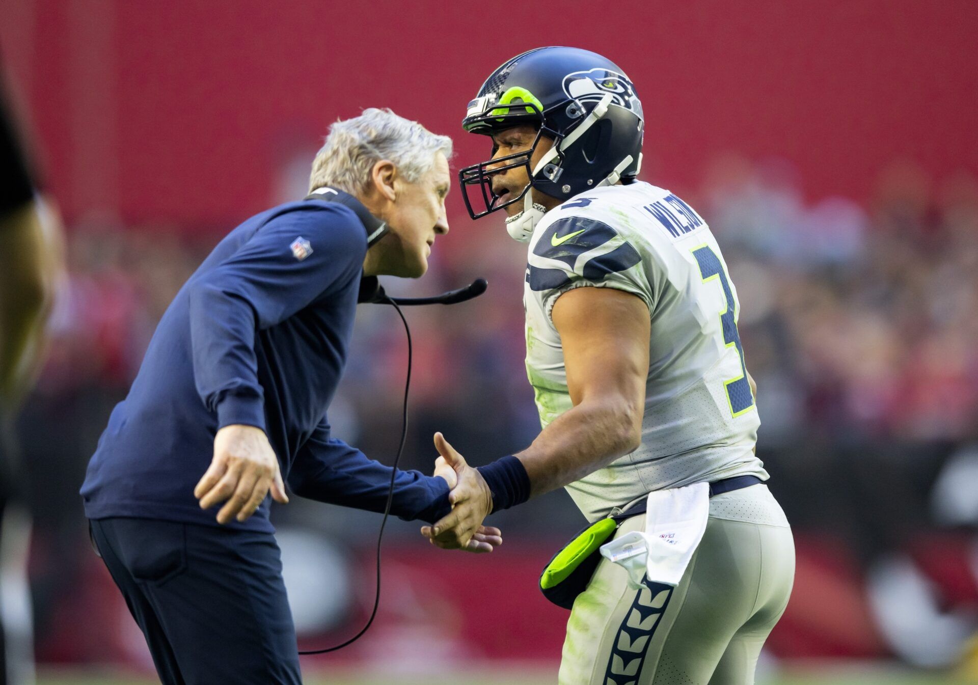 Seattle Seahawks quarterback Russell Wilson (3) celebrates a touchdown with head coach Pete Carroll against the Arizona Cardinals in the first half at State Farm Stadium.