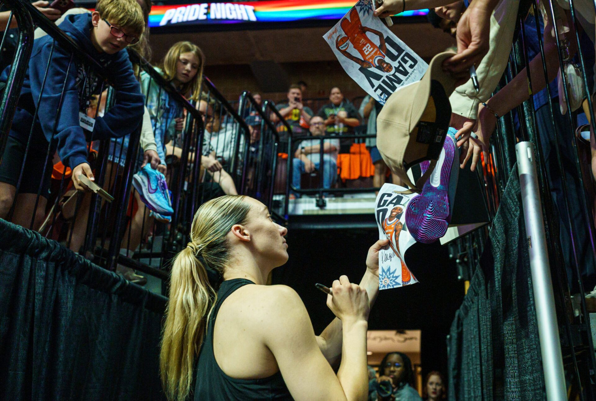 Dallas Wings guard Paige Bueckers (5) signs autographs after warming up before the start of the game against the Connecticut Sun at Mohegan Sun Arena.