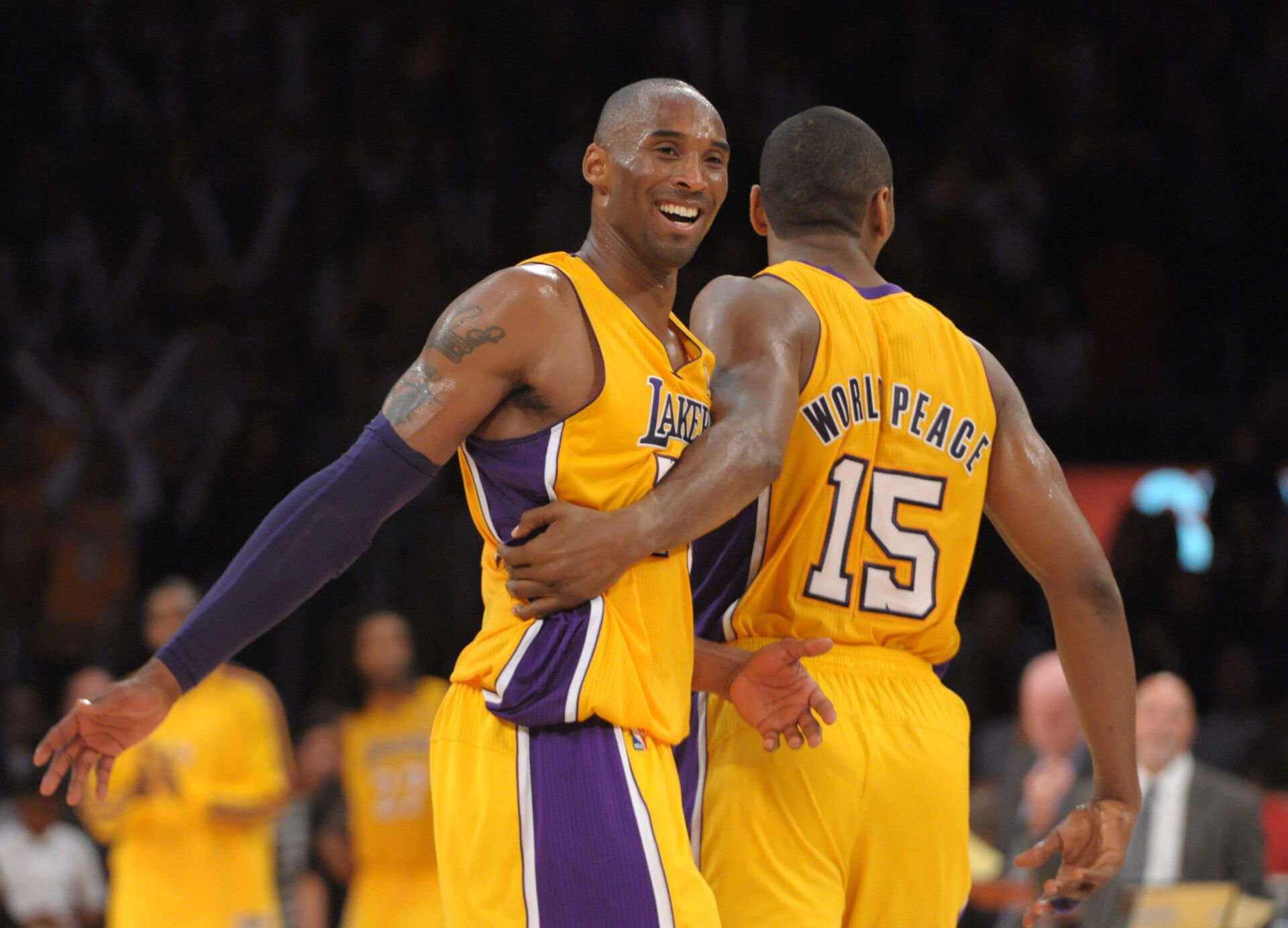 Los Angeles Lakers guard Kobe Bryant (24) and forward Metta World Peace (15) react in the fourth quarter against the Brooklyn Nets at the Staples Center. The Lakers defeated the Nets 95-90.
