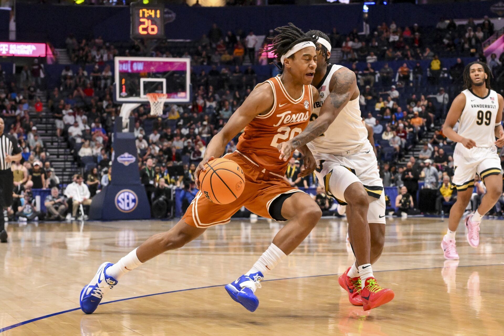Texas Longhorns guard Tre Johnson (20) dribbles past Vanderbilt Commodores guard MJ Collins Jr. (2) during the second half at Bridgestone Arena.