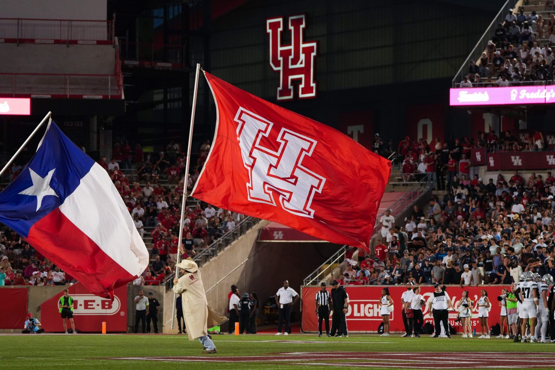 The Minute-men bring the University of Houston flag out after a Houston Cougars touchdown in the second half against the Rice Owls at TDECU Stadium.