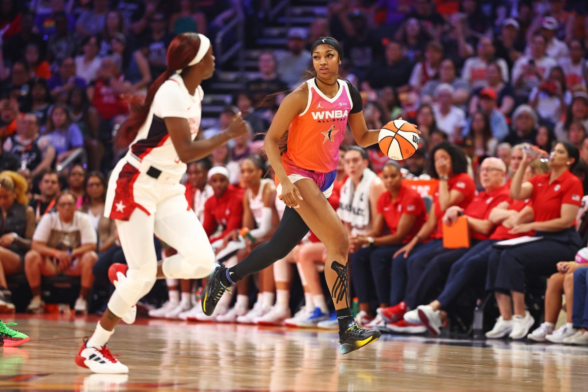 Team WNBA forward Angel Reese (5) drives to the basket during the first half as USA Women's National Team guard Kahleah Copper (7) defends at Footprint Center.