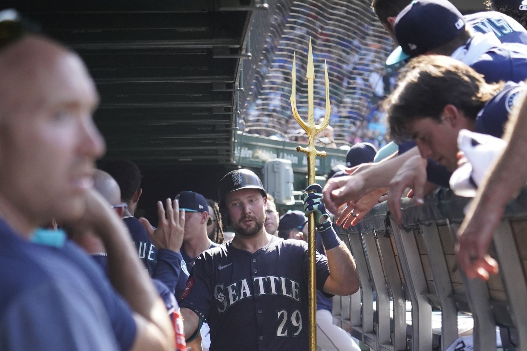 Seattle Mariners catcher Cal Raleigh (29) is greeted in the dugout after hitting a home run against the Chicago Cubs during the ninth inning at Wrigley Field.