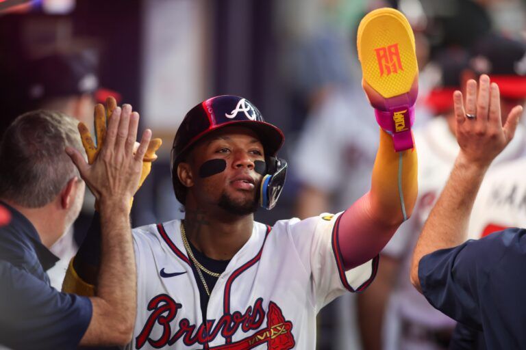 Atlanta Braves right fielder Ronald Acuna Jr. (13) celebrates with teammates after scoring a run against the New York Mets in the fifth inning at Truist Park.