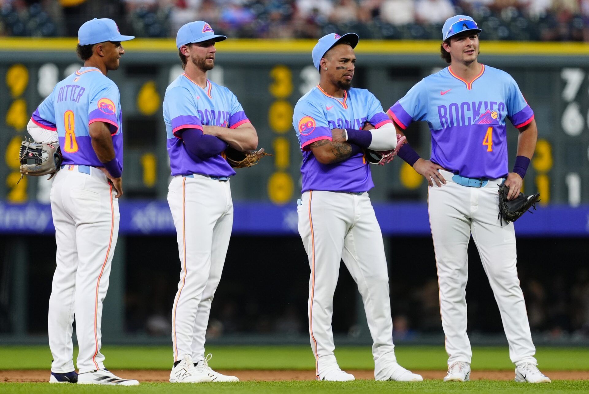 Colorado Rockies shortstop Ryan Ritter (8) and third baseman Ryan McMahon (24) and shortstop Orlando Arcia (11) and first baseman Michael Toglia (4) during the fifth inning against the Arizona Diamondbacks at Coors Field.