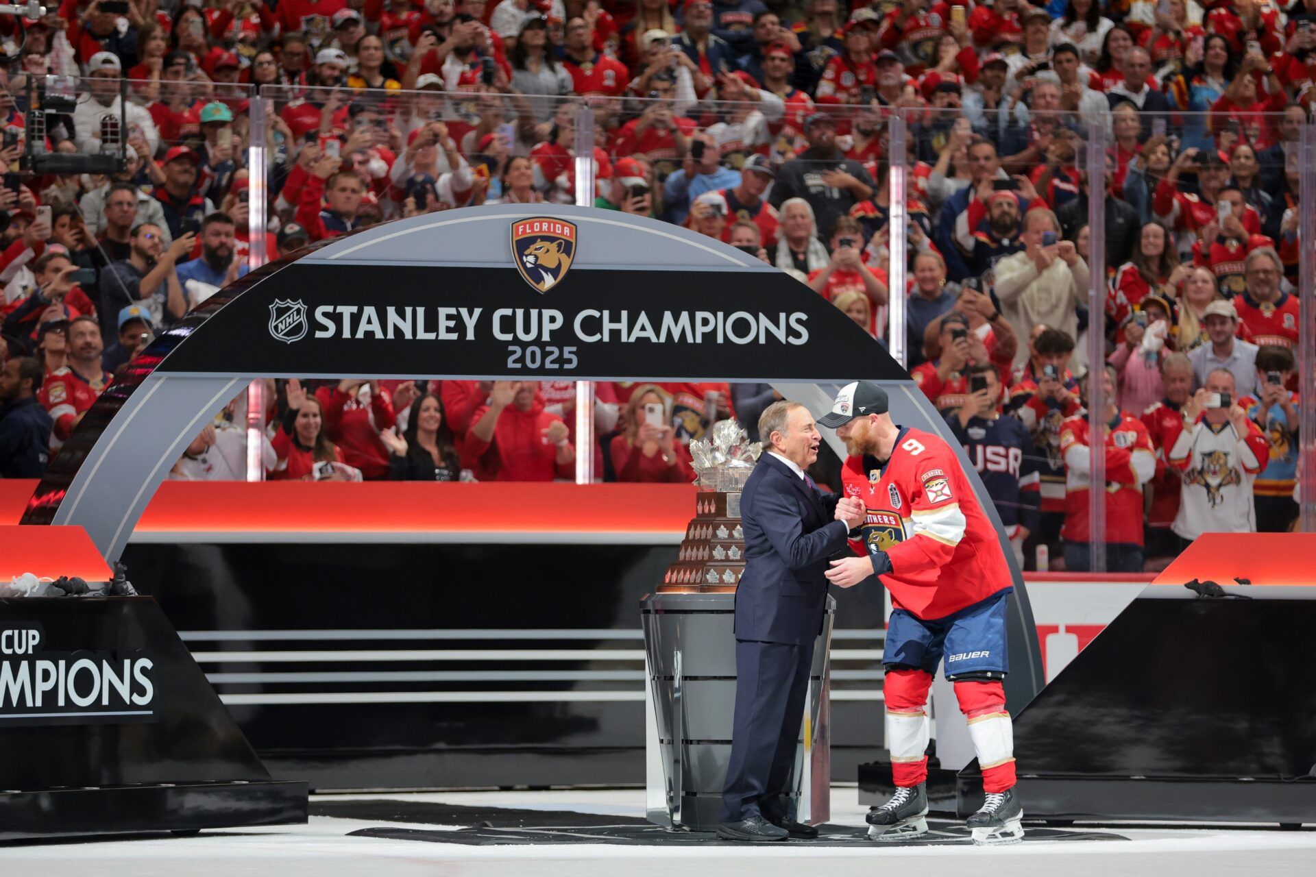 Gary Bettman, NHL Commissioner, presents Florida Panthers center Sam Bennett (9) the Conn Smythe Trophy after winning game six of the 2025 Stanley Cup Final against the Edmonton Oilers at Amerant Bank Arena.