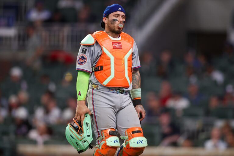 New York Mets catcher Francisco Alvarez (4) walks to the dugout against the Atlanta Braves in the eighth inning at Truist Park.