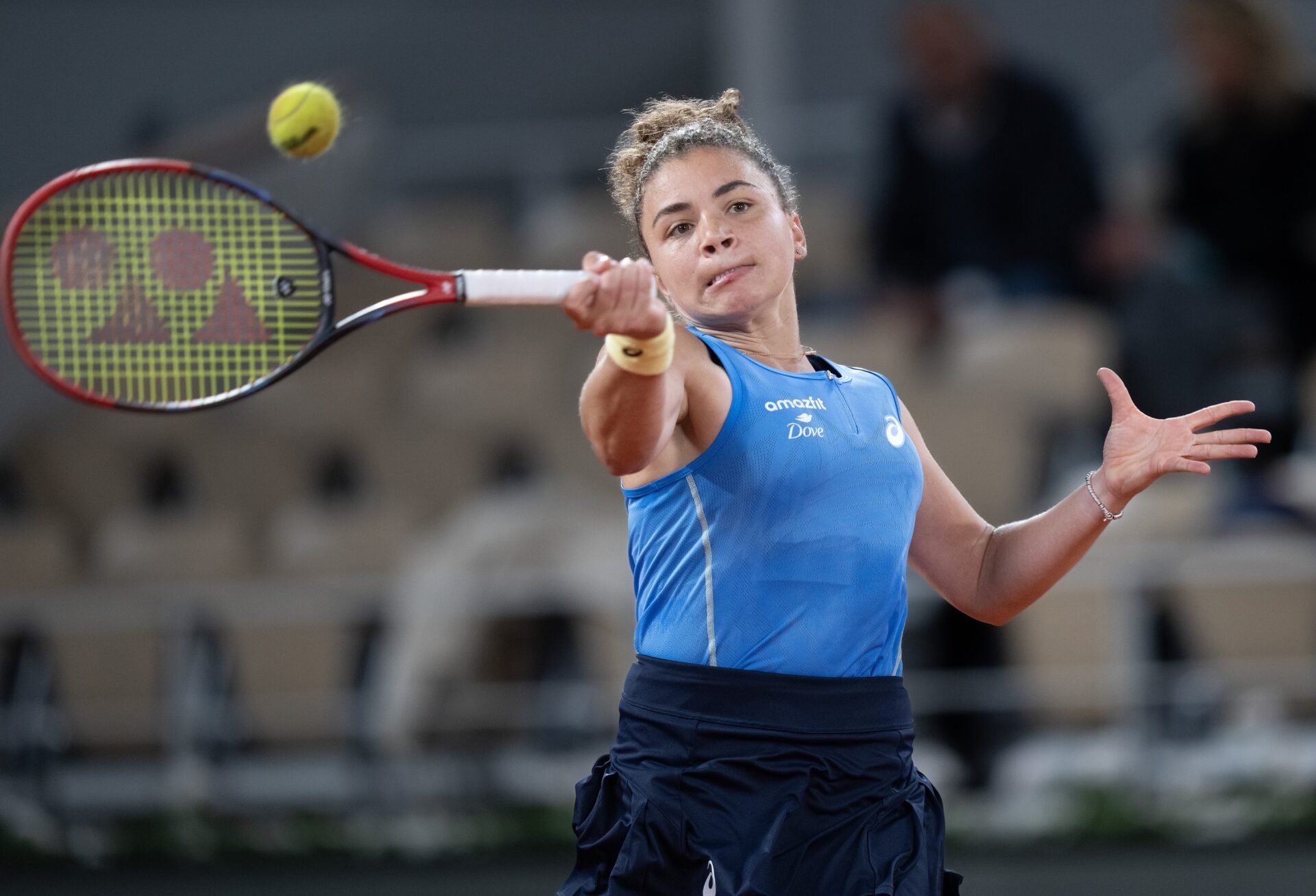 Jasmine Paolini of Italy returns a shot during her match against Aja Tomljanovic of Australia on day four at Roland Garros Stadium.