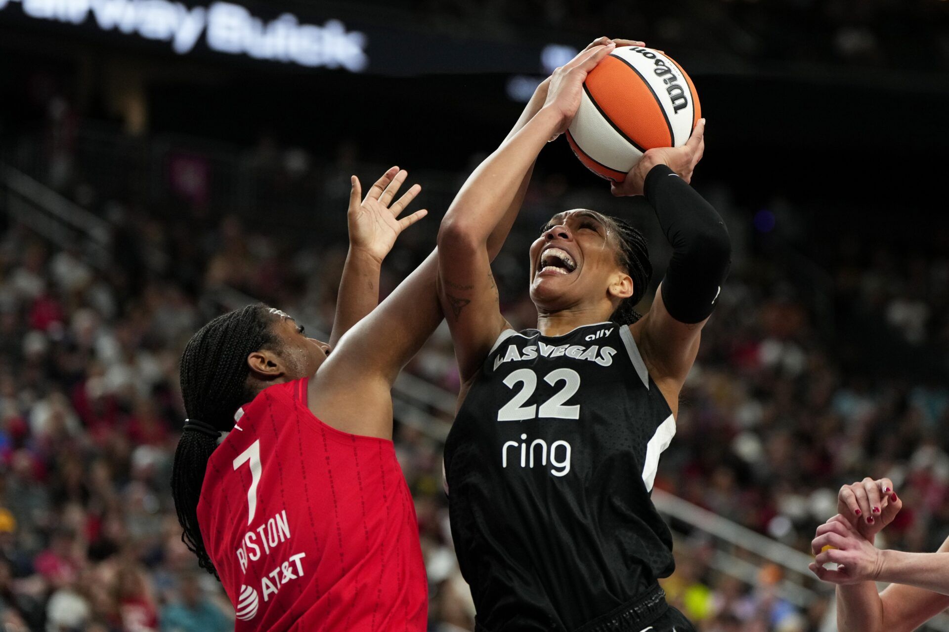 Las Vegas Aces center A'ja Wilson (22) battles for the ball against Indiana Fever center Aliyah Boston (7) during the first half of a WNBA basketball game at T-Mobile Arena.