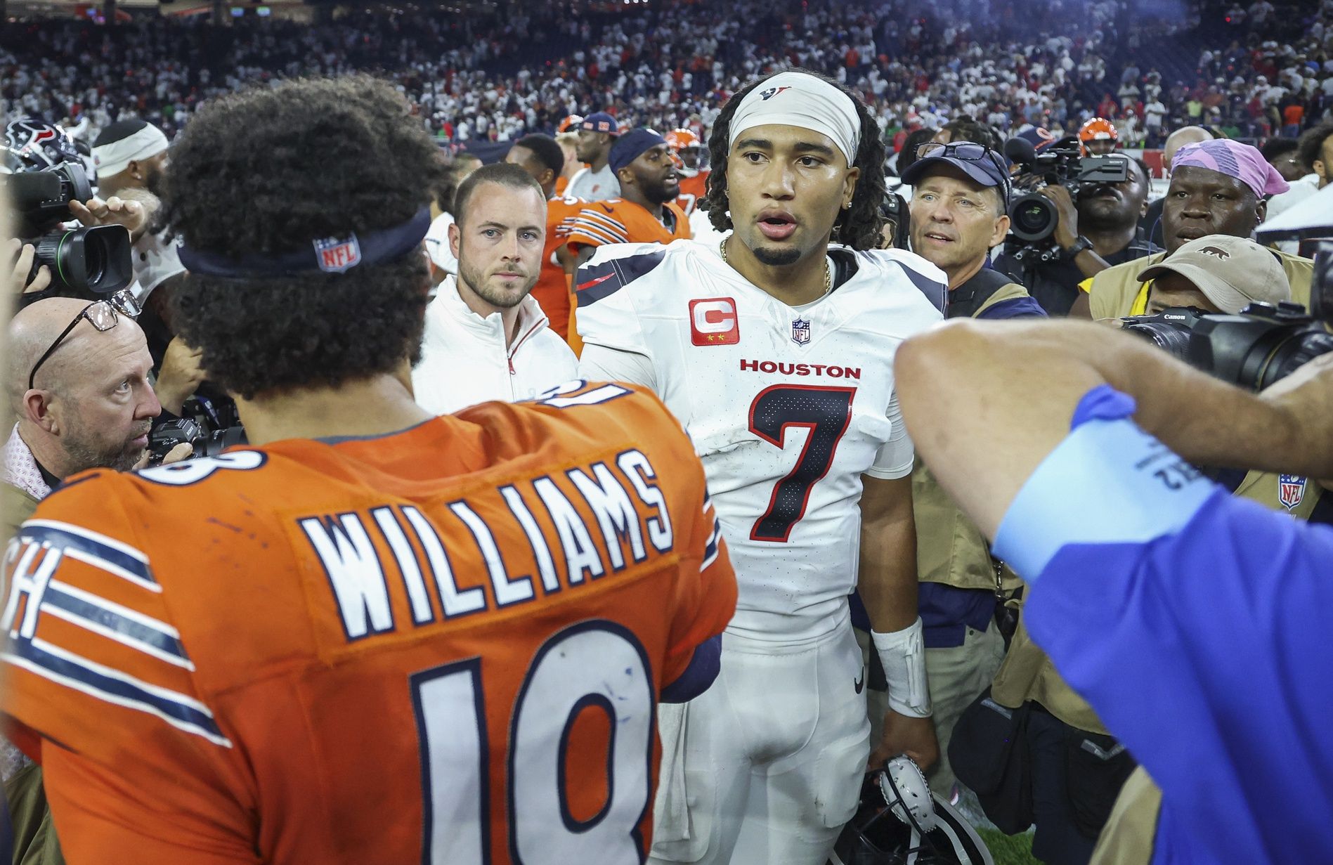 Houston Texans quarterback C.J. Stroud (7) talks with Chicago Bears quarterback Caleb Williams (18) on the field after the game at NRG Stadium.