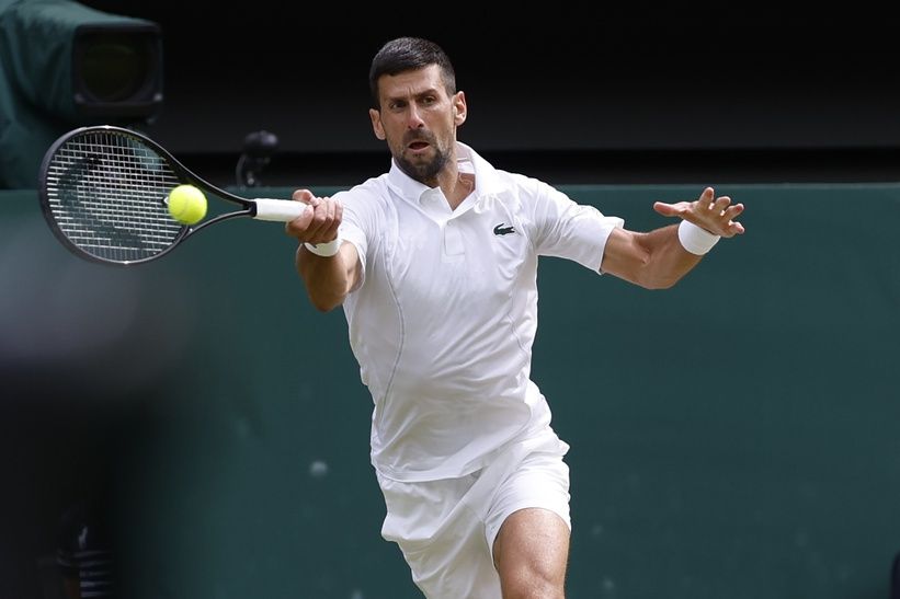 Novak Djokovic (SRB) hits a forehand against Carlos Alcaraz (ESP)(not pictured) in the gentlemen's singles final of The Championships Wimbledon 2024 at The All England Lawn Tennis and Croquet Club.
