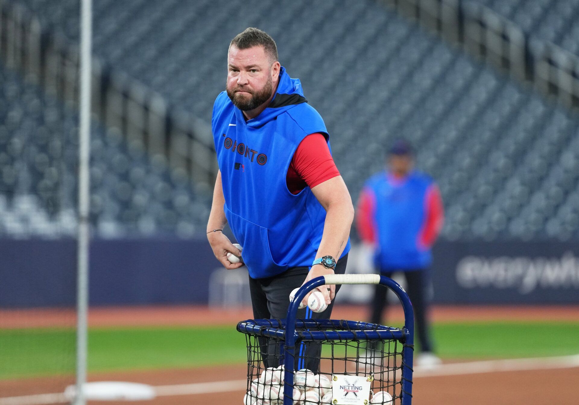 Toronto Blue Jays manager John Schneider (14) throws  baseballs during batting practice before a game against the Chicago White Sox at Rogers Centre.