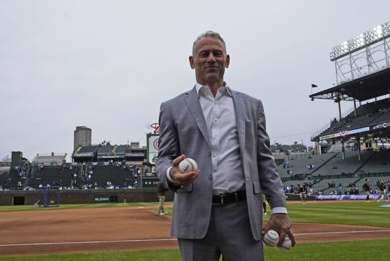 Jed Hoyer President of the Chicago Cubs prepares to throw balls to fans before a game against the San Diego Padres at Wrigley Field.
