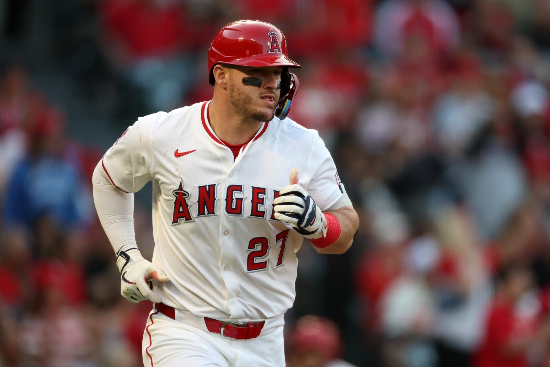 Los Angeles Angels designated hitter Mike Trout (27) runs to a first base on a single during the third inning against the Houston Astros at Angel Stadium.